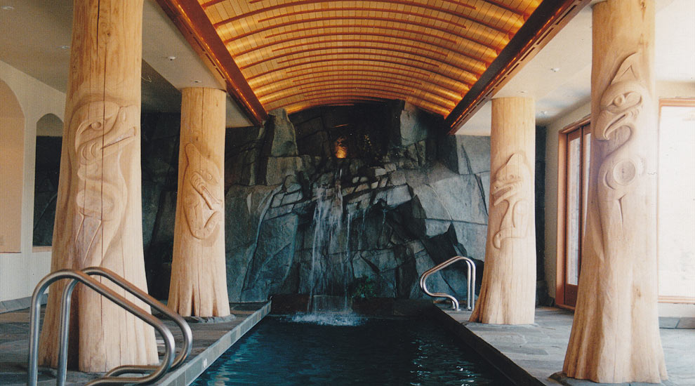 A lap pool developed as part of a larger West Coast architerctural design, including totem poles and other west coast themes. The waterscape waterfall falls directly into the lap pool.